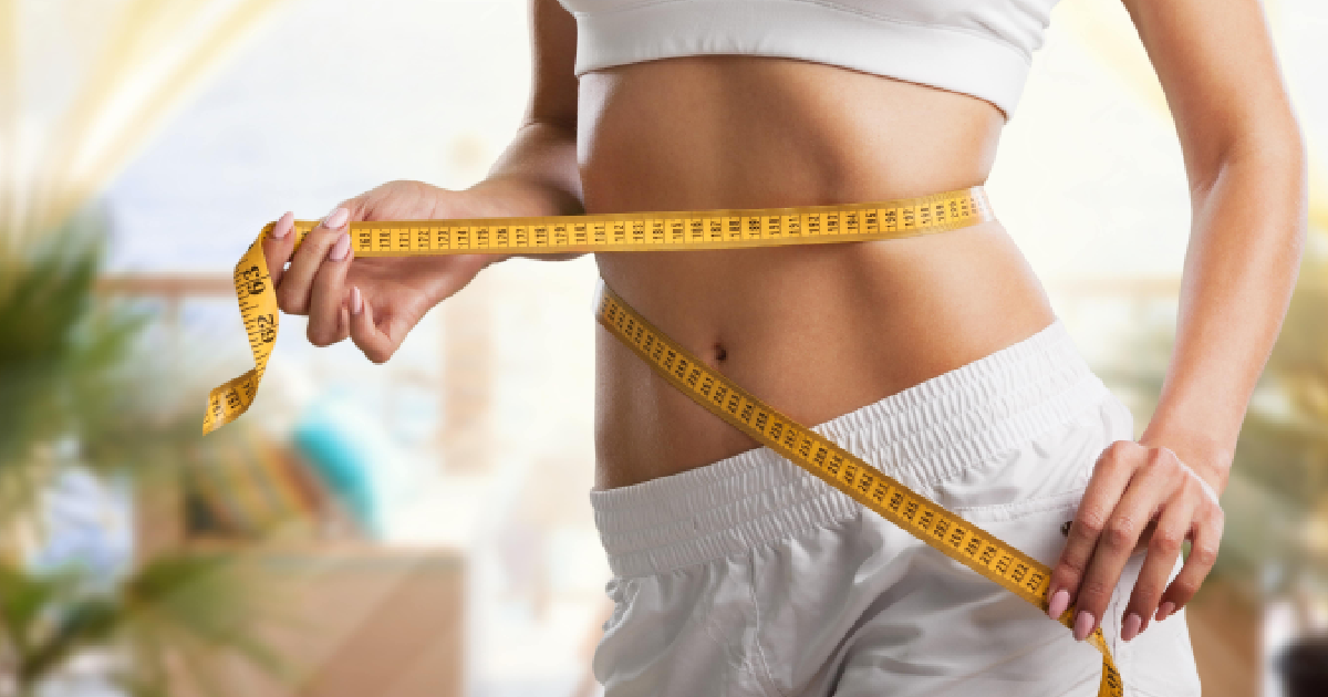 Women measuring her body after medical weight loss treatment in St. George, UT