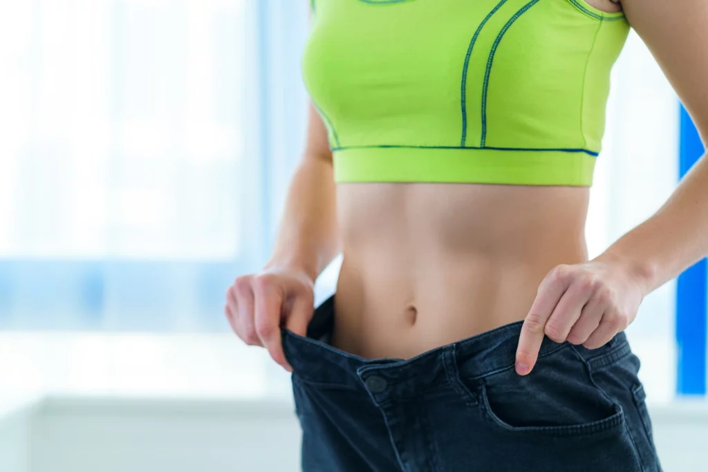 Woman in green top wearing loose waist trouser | Mesa Medical Health & Wellness | St. George, UT
